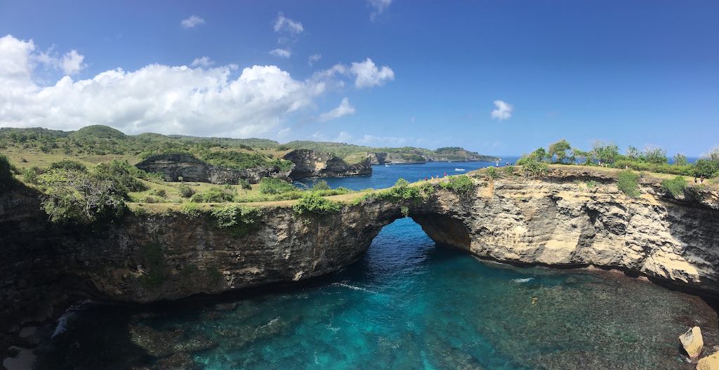 The natural rock archway of Broken Beach with the ocean flowing through it